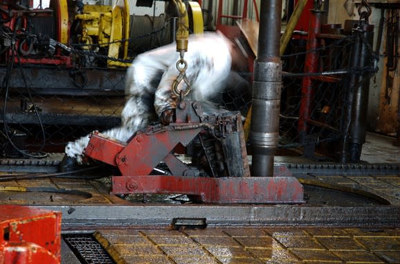 Oil rig worker setting a drill pipe.