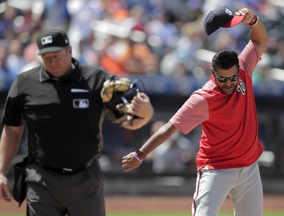 Washington Nationals manager Dave Martinez, right, reacts after being ejected by home plate umpire Bruce Dreckman for arguing after Nationals' Howie Kendrick was called out on strikes during the eighth inning of a baseball game against the New York Mets, Thursday, May 23, 2019, in New York. (AP Photo/Julio Cortez)