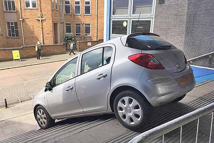 It looks like a scene from a film, but this car was spotted stuck on a flight of steps after its elderly driver took a wrong turn after following her sat nav.