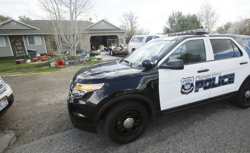 Pleasant Grove Police investigate the scene where seven infant bodies were discovered and packaged in separate containers at a home in Pleasant Grove,Utah, Sunday, April 13, 2014. According to the Pleasant Grove Police Department, seven dead infants were found in the former home of Megan Huntsman, 39. Huntsman was booked into jail on six counts of murder. (AP Photo/Deseret News, Jeffrey D. Allred) MANDATORY CREDIT