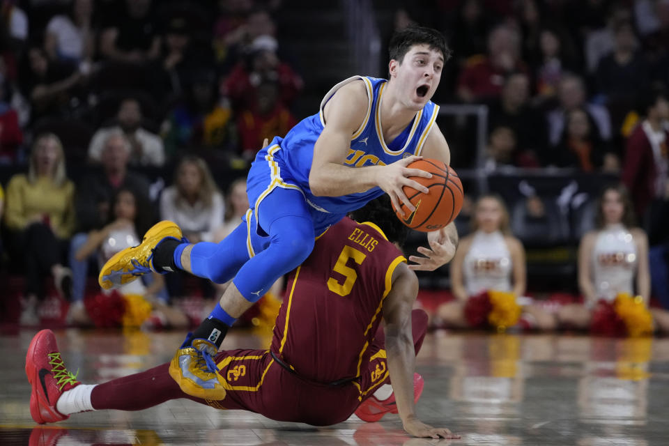 UCLA guard Lazar Stefanovic, left, collides with Southern California guard Boogie Ellis during the second half of an NCAA college basketball game, Saturday, Jan. 27, 2024, in Los Angeles. (AP Photo/Ryan Sun)