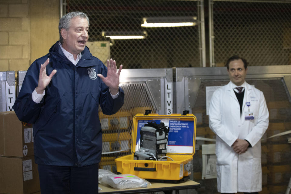 New York City Mayor Bill de Blasio, left, discusses the arrival of a shipment of 400 ventilators with Dr. Steven Pulitzer, the Chief Medical Officer of NYC Health and Hospitals, at the city's Emergency Management Warehouse., Tuesday, March 24, 2020, in New York. (AP Photo/Mark Lennihan)