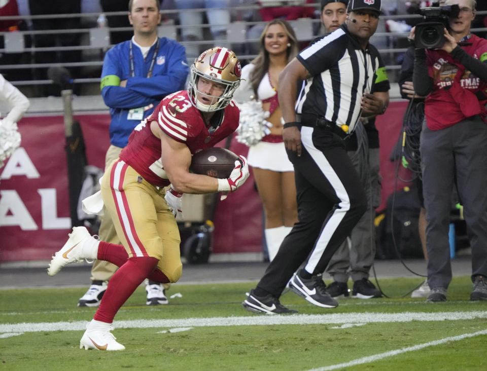 Dec 17, 2023; Glendale, Ariz, United States; San Francisco 49ers running back Christian McCaffrey (23) runs in for a touchdown against the Arizona Cardinals during the third quarter at State Farm Stadium.