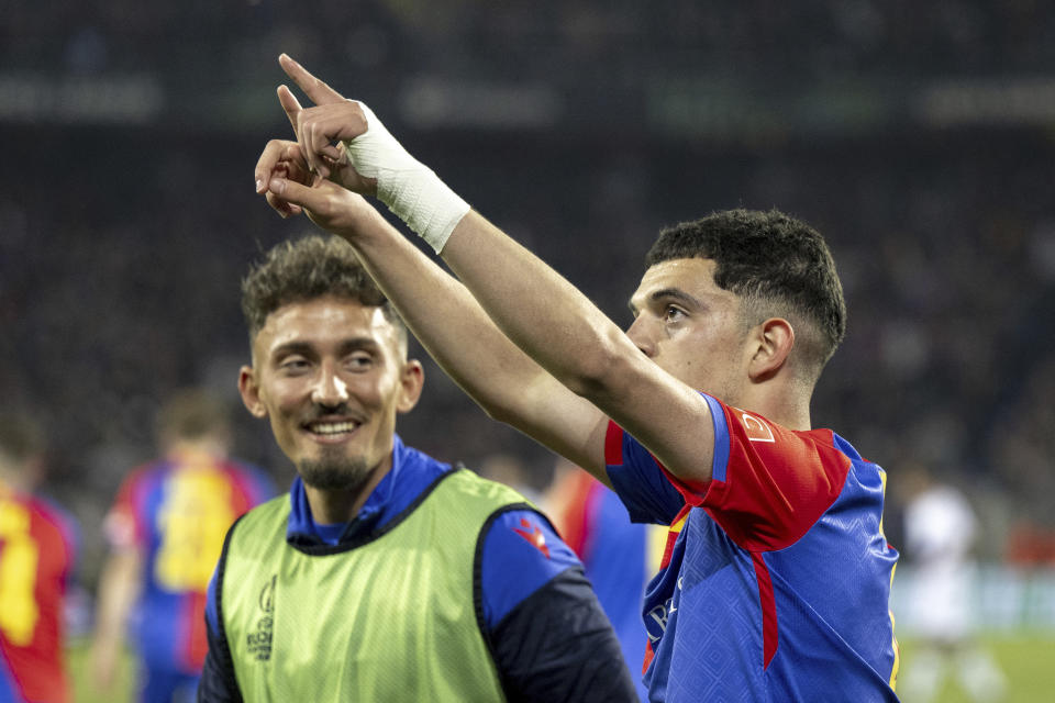 Basel's scorer Zeki Amdouni, right, and his teammate Andi Zeqiri, left, celebrate their side's first goal during the UEFA Conference League semifinal second leg match between FC Basel 1893 and ACF Fiorentina in Basel, Switzerland, Thursday, May 18, 2023. (Georgios Kefalas/Keystone via AP)