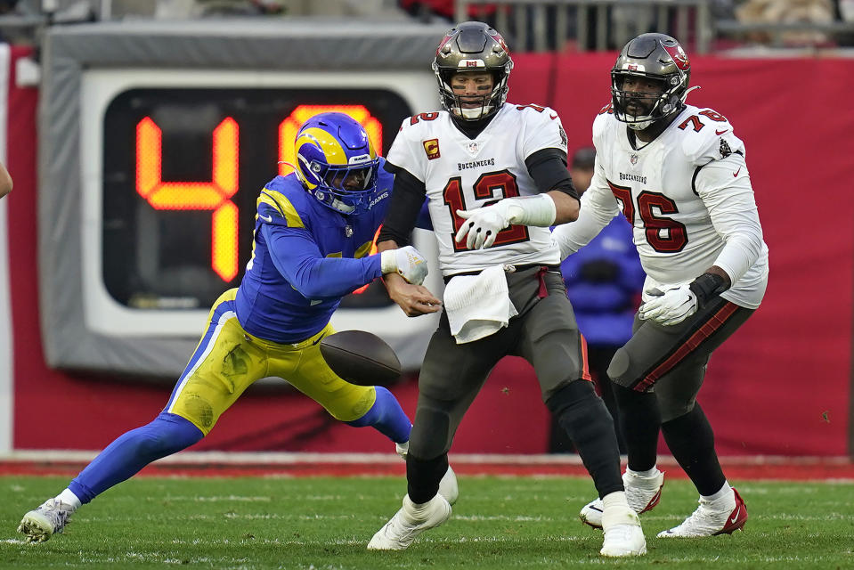 Los Angeles Rams outside linebacker Von Miller (40) strips the ball from Tampa Bay Buccaneers quarterback Tom Brady (12) during the second half of an NFL divisional round playoff football game Sunday, Jan. 23, 2022, in Tampa, Fla. (AP Photo/John Raoux)