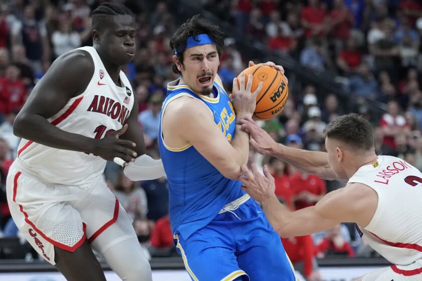 UCLA's Jaime Jaquez Jr. drives between Arizona's Oumar Ballo and Arizona's Pelle Larsson.