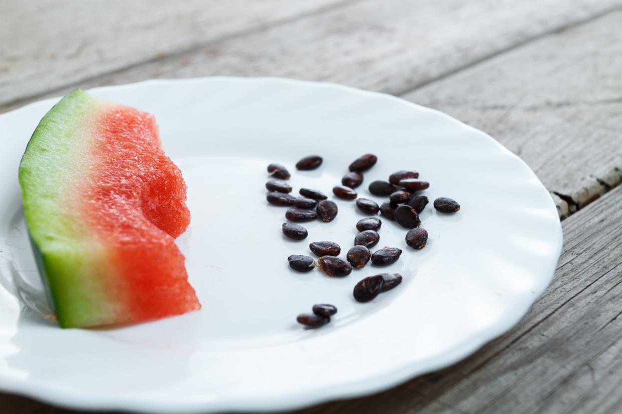 eaten slice of watermelon with watermelon seeds