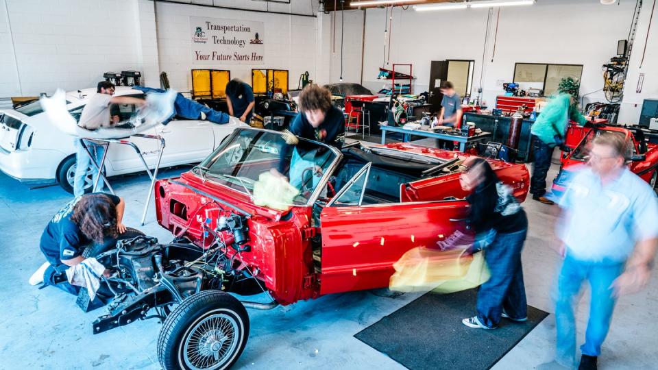 a group of people working on a car