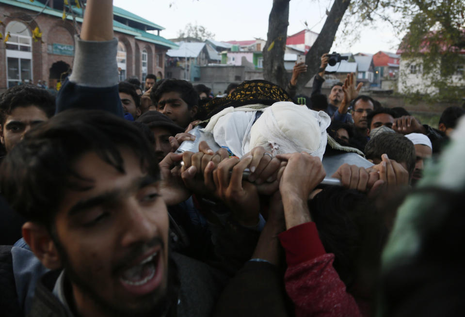 Kashmiri villagers shout pro-freedom slogans as they carry the body of Uzair Mushtaq during his funeral in Kulgam 75 Kilometers south of Srinagar, Indian controlled Kashmir, Sunday, Oct. 21, 2018. Three local rebels were killed in a gunbattle with Indian government forces in disputed Kashmir on Sunday, and six civilians were killed in an explosion at the site after the fighting was over, officials and residents said. (AP Photo/Mukhtar Khan)