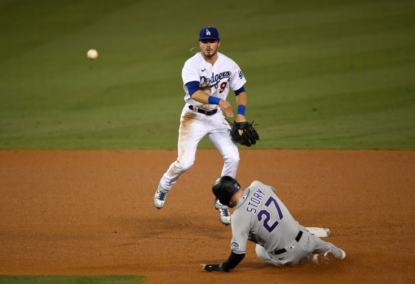 LOS ANGELES, CA - SEPTEMBER 04: Gavin Lux #9 of the Los Angeles Dodgers throws to first base to turn a double play.
