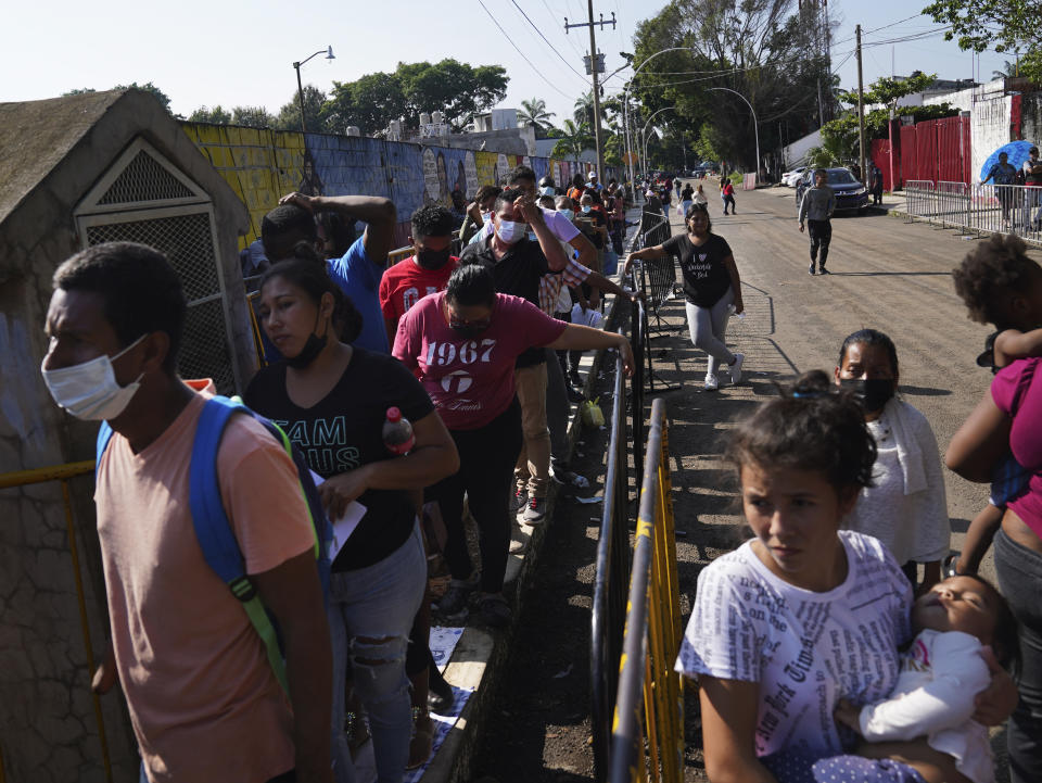 Migrants wait in line for their turn to apply for legal migration documents outside the National Immigration Institute in Tapachula, Chiapas state, Mexico, Tuesday, Oct. 4, 2022. Migrants use “safe passage” permits _ the common term for some of the temporary documents issued by the Mexican government. Most allow the holder to leave the country through any border, including the one with the United States. (AP Photo/Marco Ugarte)