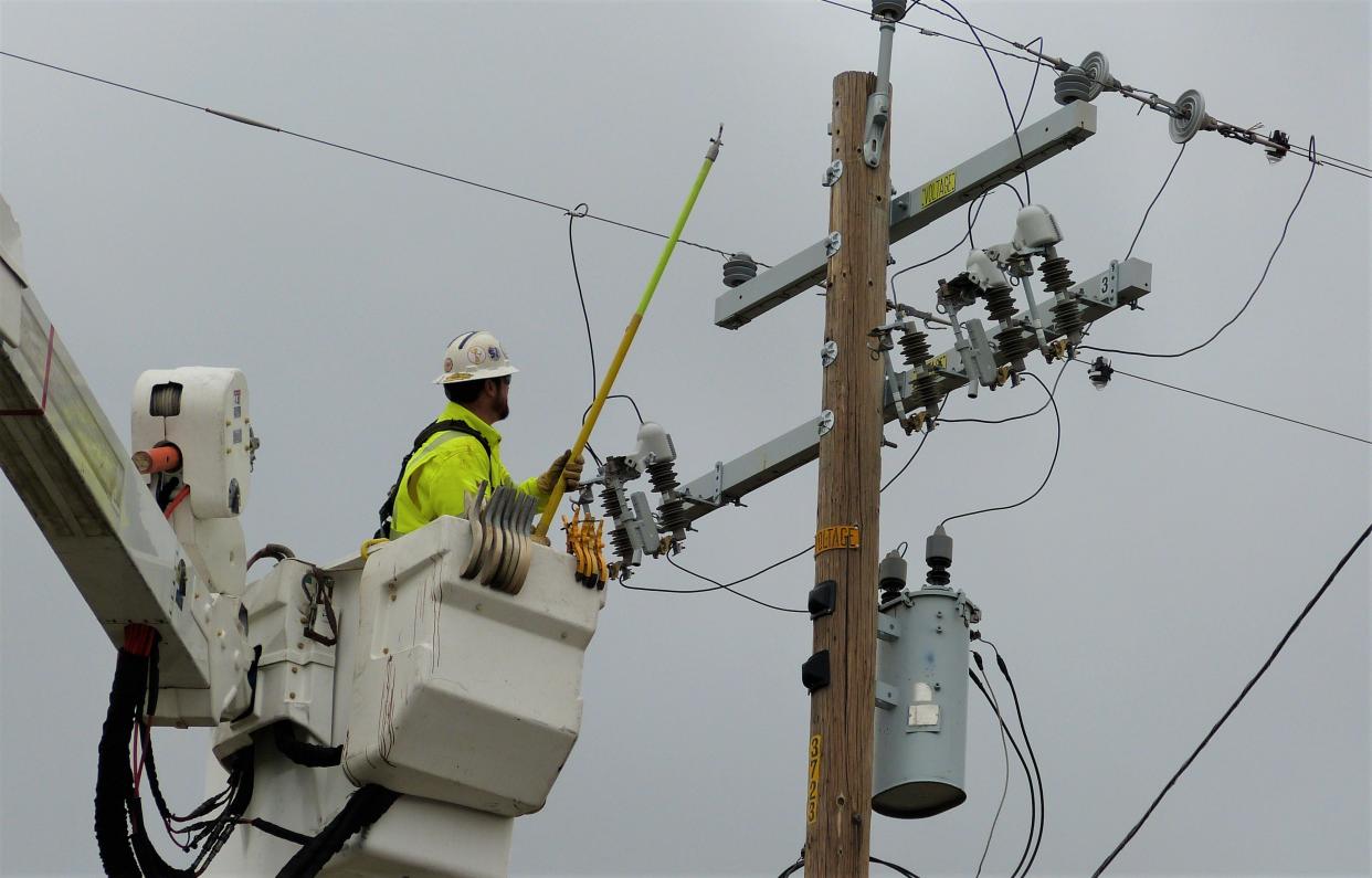 A Pacific Gas and Electric Company crew works on a line off Dersch Road near Anderson after power was knocked out during a wind storm Thursday, Jan. 5, 2023.