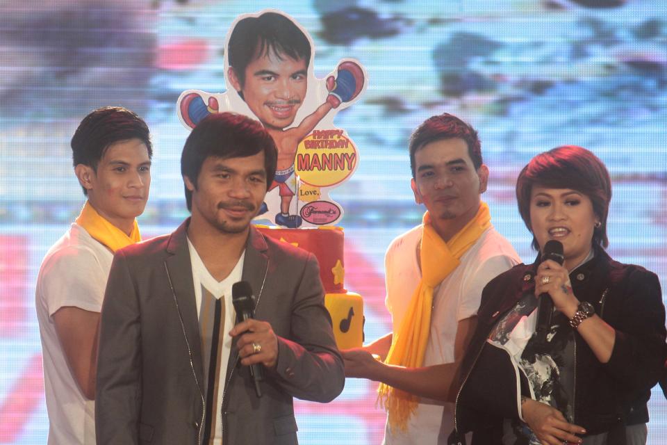 Manny receives his birthday cake during the homecoming event for The Filipino champ Manny Pacquiao, held at the Music Hall of the Mall of Asia in Pasay city, south of Manila, on 12 December 2012. (George Calvelo/NPPA Images)