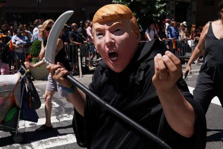 A person dressed up U.S. President Donald Trump as the Grim Reaper participates in the LGBT Pride March in the Manhattan borough of New York City, U.S., June 25, 2017. REUTERS/Carlo Allegri