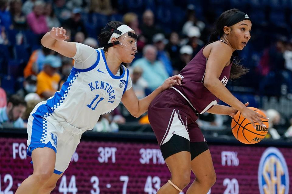 Mississippi State's Anastasia Hayes, right, protects the ball from Kentucky guard Jada Walker (11) in the first half of an NCAA college basketball game at the women's Southeastern Conference tournament Thursday, March 3, 2022, in Nashville, Tenn. (AP Photo/Mark Humphrey)