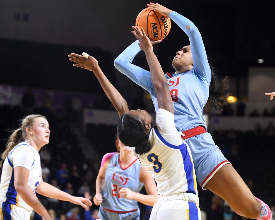 USJ's Haylen Ayers (20) draws a foul call on Goodpasture's Addi Ruffin (3) during the 2024 BlueCross Girls Division II Class A State Championship match between Goodpasture and USJ in Hooper Eblen Center in Cookeville, Tenn., on Saturday, Mar. 2, 2024.