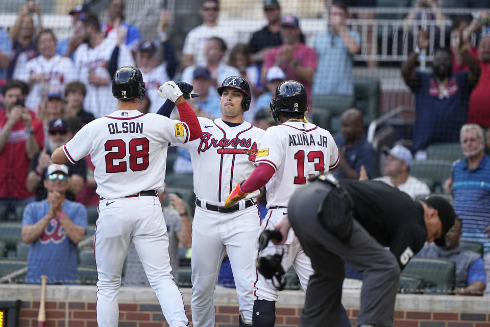 Atlanta Braves' Matt Olson (28) celebrates with Austin Riley, center, after hitting a two-run home run in the first inning of a baseball game against the Philadelphia Phillies, Sunday, May 28, 2023, in Atlanta. (AP Photo/Brynn Anderson)