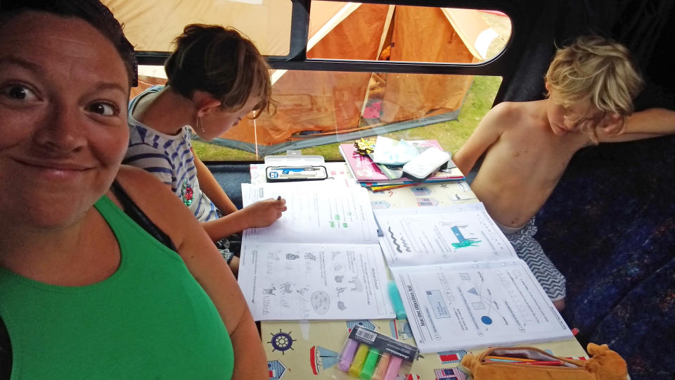 Kate Hennessey Bowers with her two children in their classroom  camper van. (Caters)