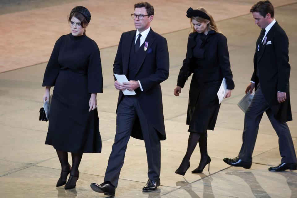 LONDON, ENGLAND - SEPTEMBER 14: (L-R) Princess Eugenie, her husband Jack Brooksbank, Princess Beatrice and husband Edoardo Mapelli Mozzi walk as procession with the coffin of Britain's Queen Elizabeth arrives at Westminster Hall from Buckingham Palace for her lying in state on September 14, 2022 in London, United Kingdom. Queen Elizabeth II's coffin is taken in procession on a Gun Carriage of The King's Troop Royal Horse Artillery from Buckingham Palace to Westminster Hall where she will lay in state until the early morning of her funeral. Queen Elizabeth II died at Balmoral Castle in Scotland on September 8, 2022, and is succeeded by her eldest son, King Charles III. (Photo by Phil Noble - WPA Pool/Getty Images)