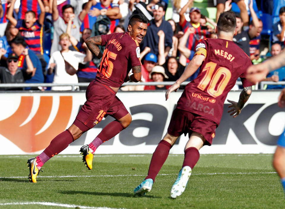 Paulinho, left, scored a late winner as Barcelona escaped Getafe with three points. (Reuters)