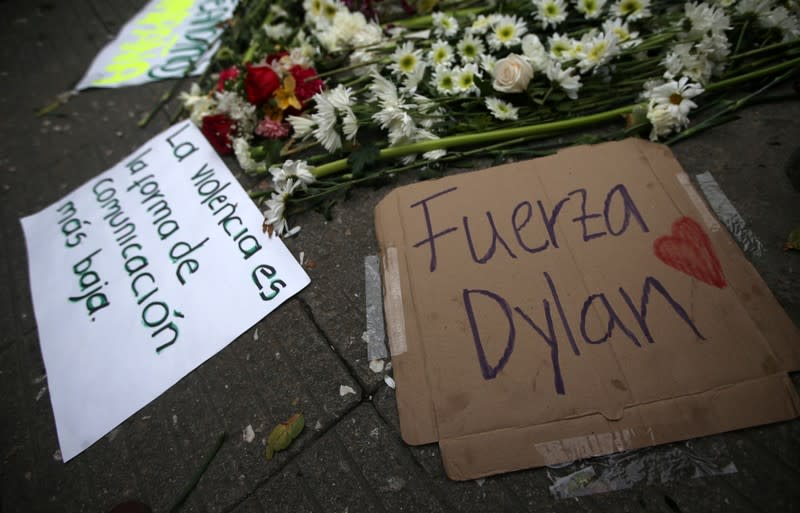 Signs lie in the street where Dilan Cruz was injured, allegedly by a tear gas canister fired by riot police during the national strike on the previous day, in Bogota