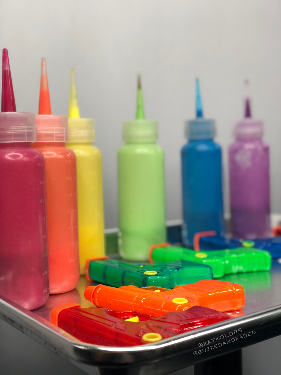 Andrew and Kat Collett, a husband-and-wife hairstylist duo, filled water guns with rainbow hair dye to create an unexpected hair-dyeing technique.