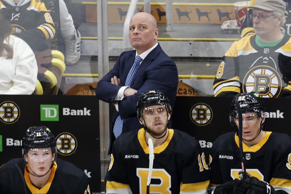 Boston Bruins head coach Jim Montgomery, top center, looks on from the bench during the first period of an NHL hockey game against the Philadelphia Flyers, Monday, Jan. 16, 2023, in Boston. (AP Photo/Mary Schwalm)