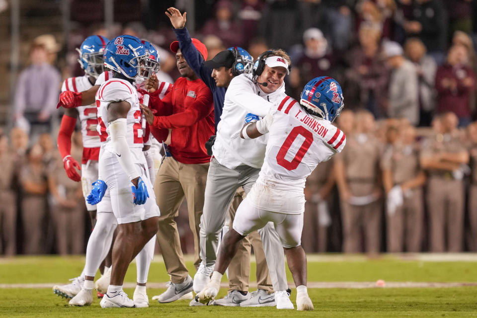Oct 29, 2022; College Station, Texas; Mississippi Rebels head coach Lane Kiffin (second from right) celebrates with safety Tysheem Johnson (0) in the second half against the Texas A&M Aggies at Kyle Field. Daniel Dunn-USA TODAY Sports
