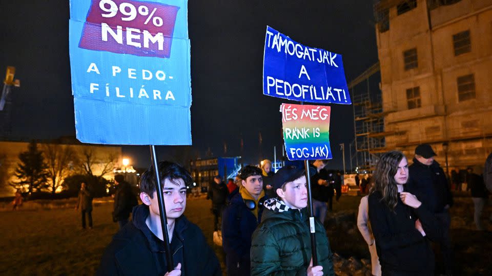"99% say no to pedophilia," reads one placard. "They [the government] support pedophilia (and they blame it on us)," reads another, during a protest in Budapest, February 14, 2024. - Attila Kisbenedek/AFP/Getty Images