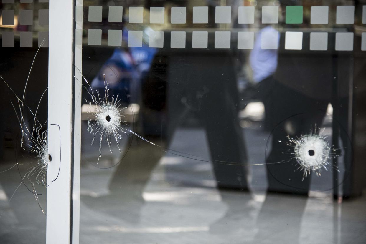 Picture of bullet holes in a window of a supermarket belonging to the family of Antonela Roccuzzo, the wife of Argentine football star Lionel Messi, after attackers fired shots at the facade of the closed premises early in the morning and left a threat message to Messi, in Rosario, Santa Fe Province, Argentina, on March 2, 2023. - Two men attacked the front of a supermarket belonging to the in-laws of Messi and left a written message mentioning the captain of the world champion Argentine team, the mayor of the city Pablo Javkin said. 