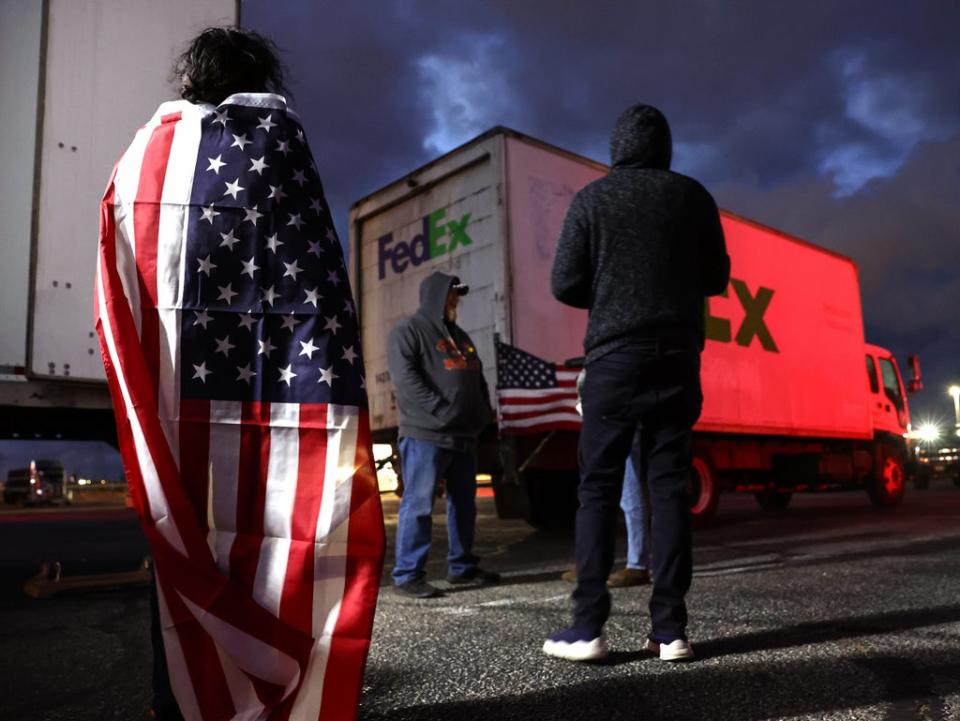 Truck-borne protesters gather before departure in Adelanto, California on 22 February (Mario Tama/Getty Images)
