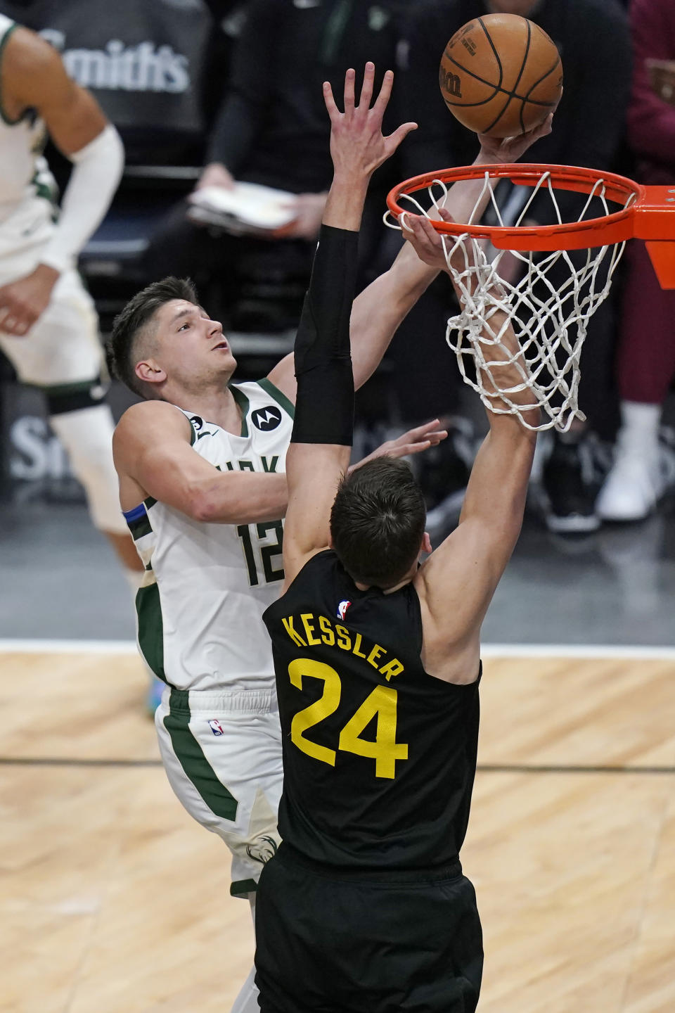 Milwaukee Bucks guard Grayson Allen (12) goes to the basket as Utah Jazz center Walker Kessler (24) defends during the first half of an NBA basketball game Friday, March 24, 2023, in Salt Lake City. (AP Photo/Rick Bowmer)