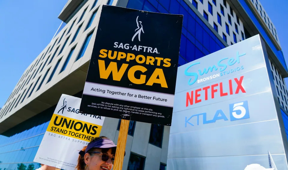 Members of actors union, SAG-AFTRA and the writers union, the WGA, picket at Bronson Studios home of Netflix on July 12, 2023.