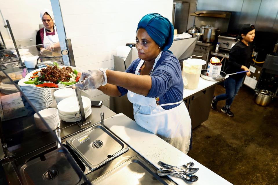 Global Cafe Sudanese chef Ibtisam Salih serves up a dish of Dama with Rous, beef over rice, in the 2,500-square-foot restaurant inside Crosstown Concourse.  The cafe features dishes from Nepalese, Syrian and Sudanese immigrants or refugees.