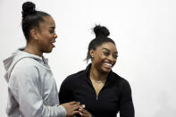 Zoe Miller, left and Simone Biles joke around before training at the Stars Gymnastics Sports Center in Katy, Texas, Monday, Feb. 5, 2024. Biles begins preparations for the Paris Olympics when she returns to competition at the U.S. Classic in Hartford, Connecticut on Saturday. Biles, who cited mental health concerns while removing herself from several competitions at the Tokyo Olympics, says she is better prepared for the pressure competing presents this time around. (AP Photo/Michael Wyke)