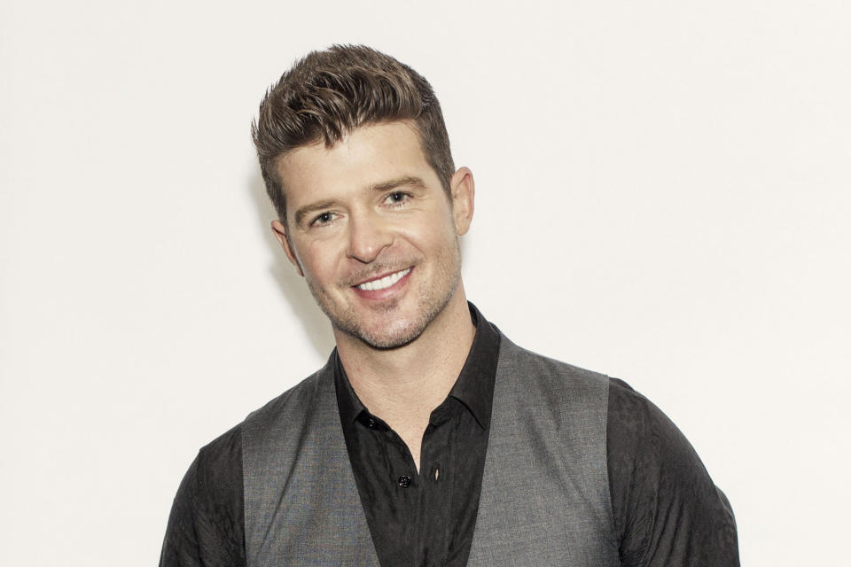 This Aug. 1, 2013 photo shows R&B singer-songwriter Robin Thicke in New York. Thicke released his fifth album, "Blurred Lines," on Aug. 2. The title track and lead single, which features T.I. and Pharrell, is the longest-running No. 1 song on the Billboard Hot 100 chart so far this year. (Photo by Victoria Will/Invision/AP)