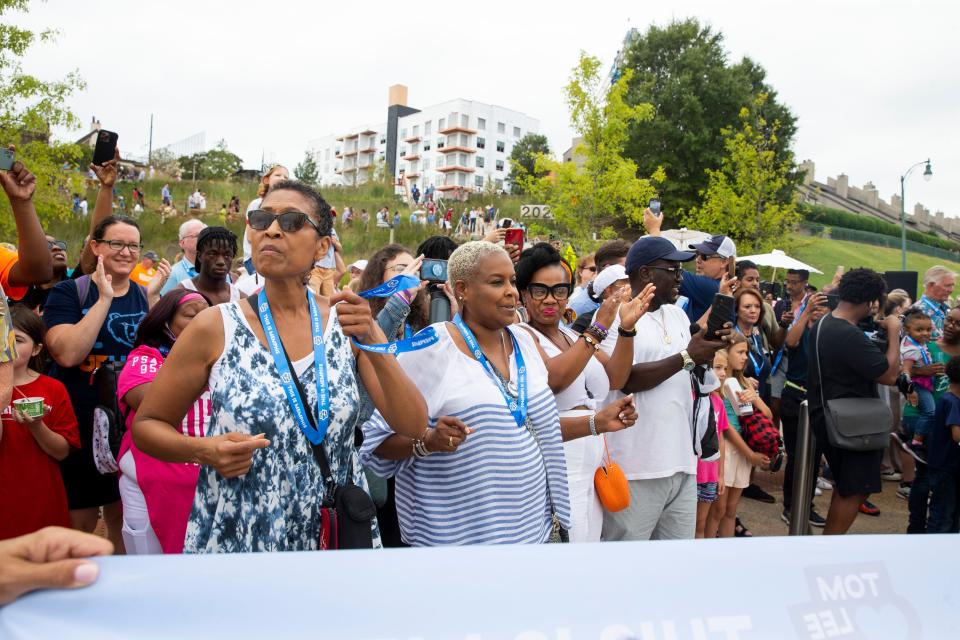 People dance to the Lucky Seven Brass Band in front of the entrance to the newly renovated Tom Lee Park prior to the ribbon cutting to officially open it to the public in Downtown Memphis on Saturday, September 2, 2023.