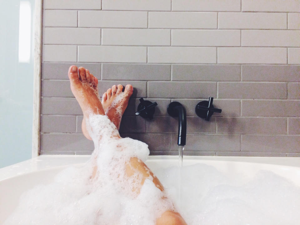 Someone's legs in a bubble bath