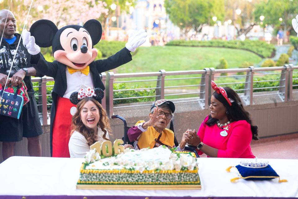 Magnolia Jackson (center), who wanted to celebrate her 106th birthday at Walt Disney World Resort in Lake Buena Vista, Fla. Jackson was showered in birthday wishes and admiration by Disney cast members and executives before she met Princess Tiana and visited EPCOT.