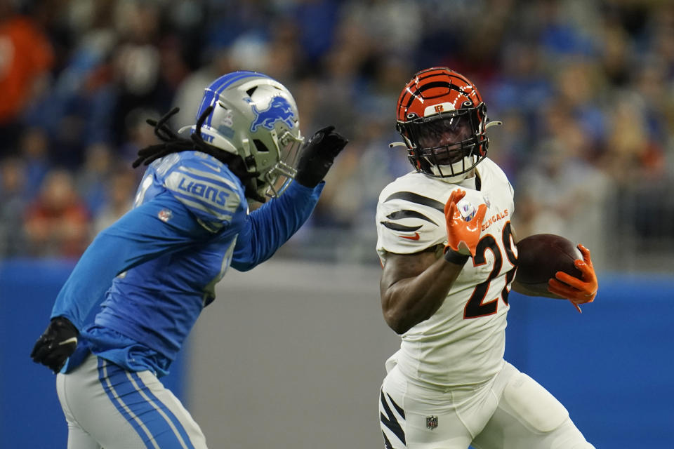 Cincinnati Bengals running back Joe Mixon (28) is chased by Detroit Lions linebacker Jalen Reeves-Maybin (44) during the first half of an NFL football game, Sunday, Oct. 17, 2021, in Detroit. (AP Photo/Paul Sancya)