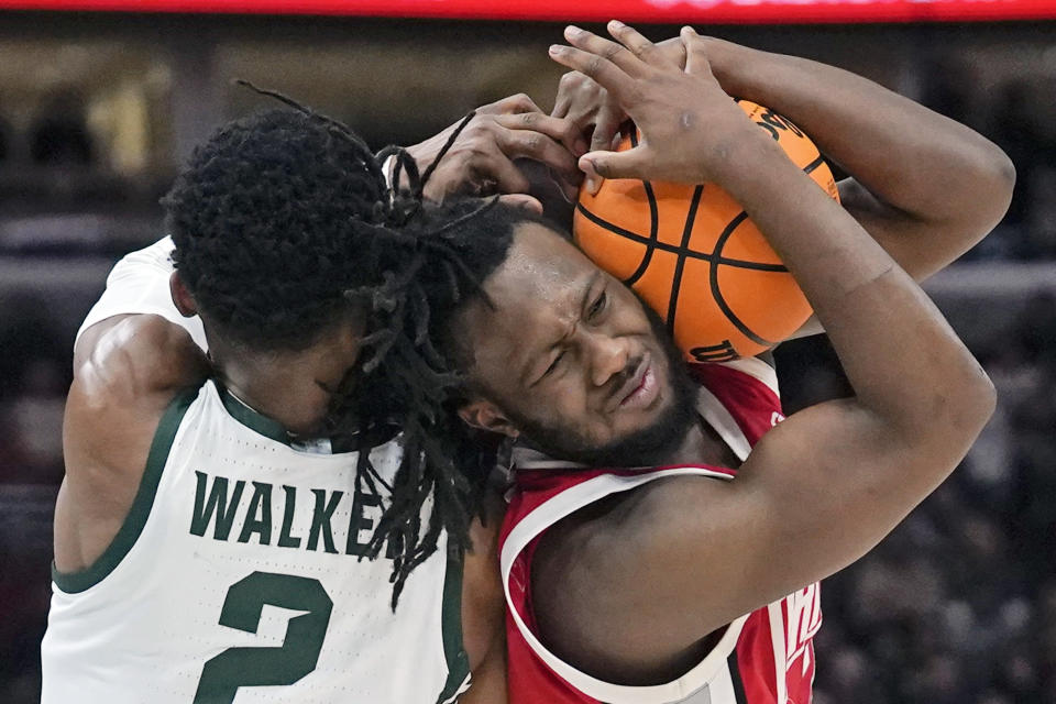 Michigan State's Tyson Walker (2) and Ohio State's Bruce Thornton (2) battle for the ball during the first half of an NCAA college basketball game at the Big Ten Conference Tournament, Friday, March 10, 2023, in Chicago. (AP Photo/Erin Hooley)