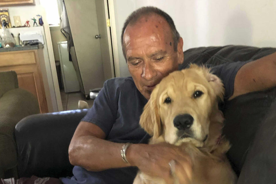 This undated photo provided by Shannon Weber-Bogar shows Franklin Trejos with his golden retriever Sam. Trejos died in the Lahaina, Hawaii wildfires while using his body to shield Sam in the back of his car. The bodies were found Wednesday, Aug. 9, 2023. (Shannon Weber-Bogar via AP)