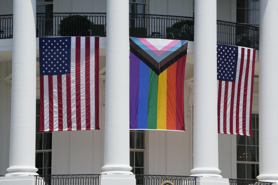American flags and a pride flag hang from the White House before a Pride Month celebration on the South Lawn, Saturday, June 10, 2023, in Washington. (AP Photo/Manuel Balce Ceneta)