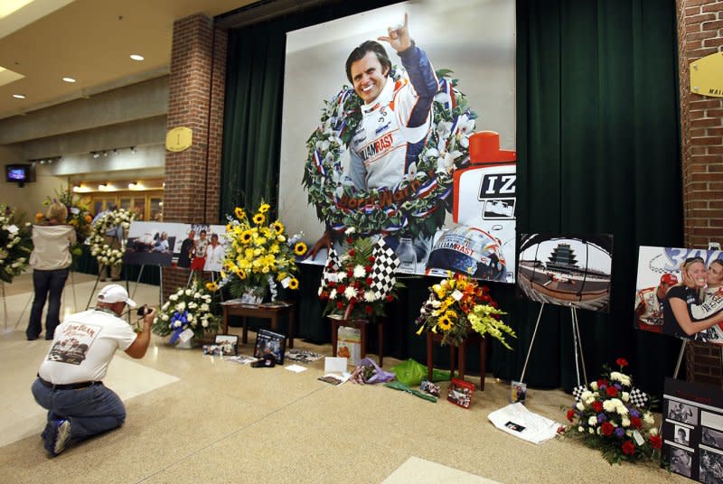 Fans take pictures and leave mementos at a memorial service for race car driver and two time Indianapolis 500 winner Dan Wheldon at Conseco Fieldhouse in Indianapolis, on October 23, 2011. Wheldon was killed in a multiple car crash at the Indy Racing League season finale in Las Vegas October 16, 2011. File Photo by Mark Cowan/UPI