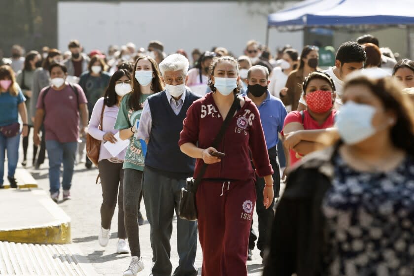 People wait in line to receive a dose of the Pfizer-BioNTech vaccine against COVID-19 in Mexico City, on December 28, 2021. (Photo by ALFREDO ESTRELLA / AFP) (Photo by ALFREDO ESTRELLA/AFP via Getty Images)