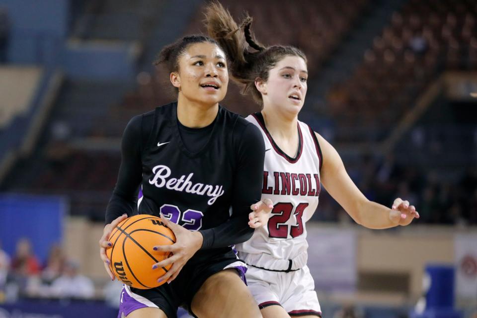 Bethany's Keziah Lofton (32) tries to get past Lincoln Christian's Kayli Atkinson (23) during the Class 4A girls state basketball championship between Bethany and Lincoln Christian at the State Fair Arena in Oklahoma City, Saturday, March 11, 2023.