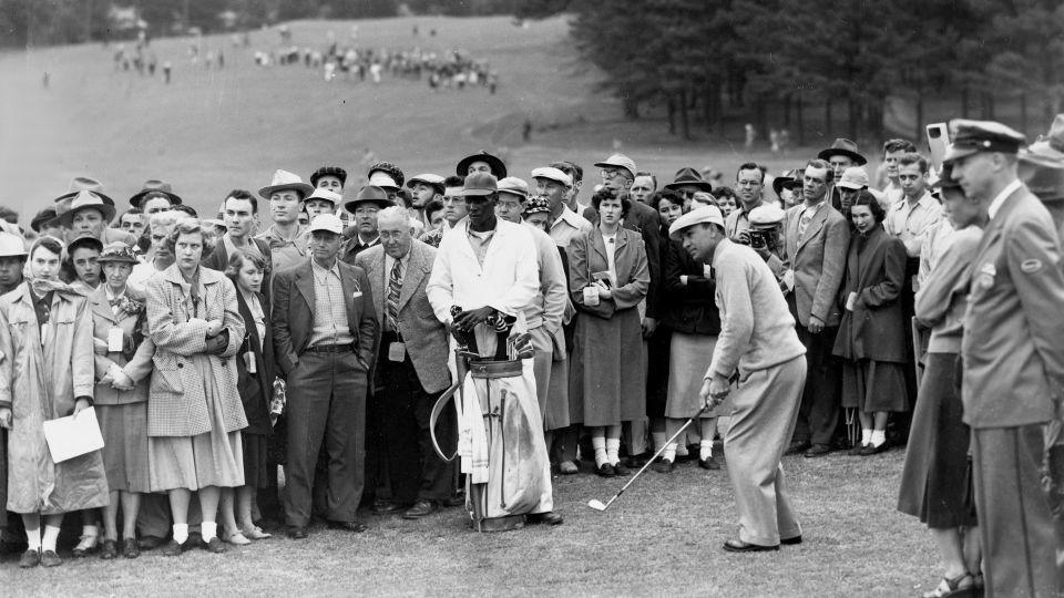 Stokes watches on as Ben Hogan edges closer to his first Masters title in 1951. Stokes would caddy again for Hogan when he won his second green jacket in 1953. - AP Photo