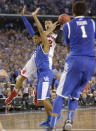 Wisconsin guard Traevon Jackson (12) is fouled by Kentucky guard Andrew Harrison (5) during the final seconds of their NCAA Final Four tournament college basketball semifinal game Saturday, April 5, 2014, in Arlington, Texas. (AP Photo/Eric Gay)