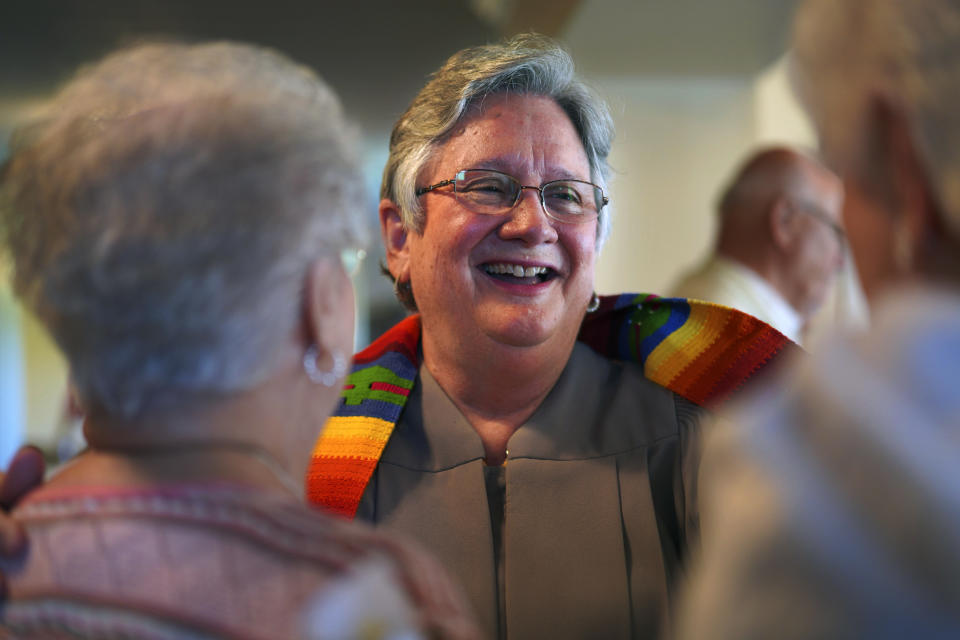 The Rev. Linda Barnes Popham, center, laughs with members of Fern Creek Baptist Church after a service, Sunday, May 21, 2023, in Louisville, Ky. In February, Fern Creek was one of five churches disfellowshipped from the Southern Baptist Convention because they have female pastors. But Fern Creek and Saddleback Church of California have decided to appeal. The challenge will be voted on at the upcoming SBC annual meeting. (AP Photo/Jessie Wardarski)