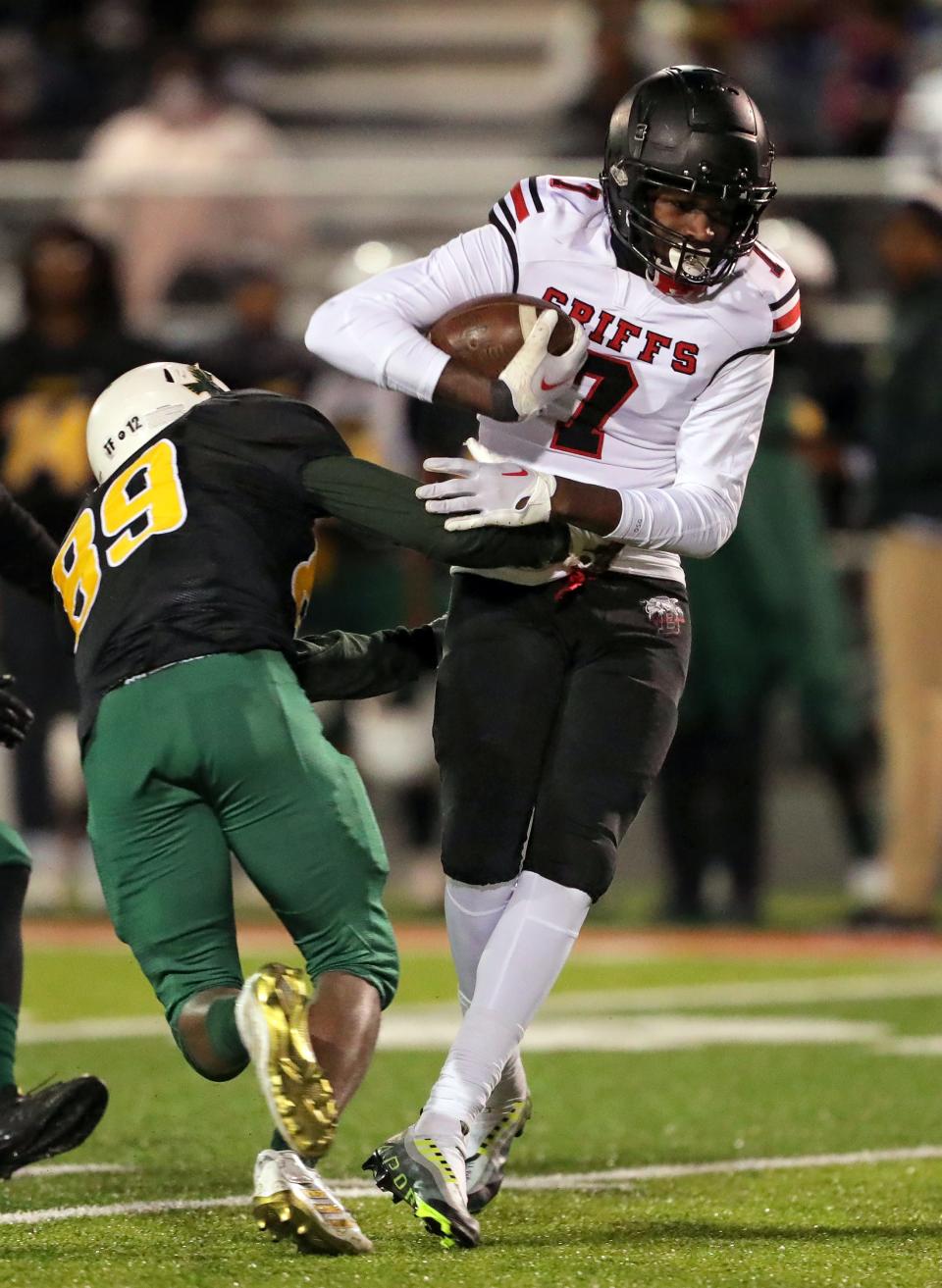 Buchtel wide receiver Dakota Taylor, right, is tackled by Firestone defensive end Gemere Lewis after a reception during the first half of a high school football game, Friday, Oct. 21, 2022, in Akron, Ohio.